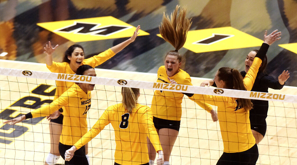 Members of the Missouri volleyball team go in for a group hug